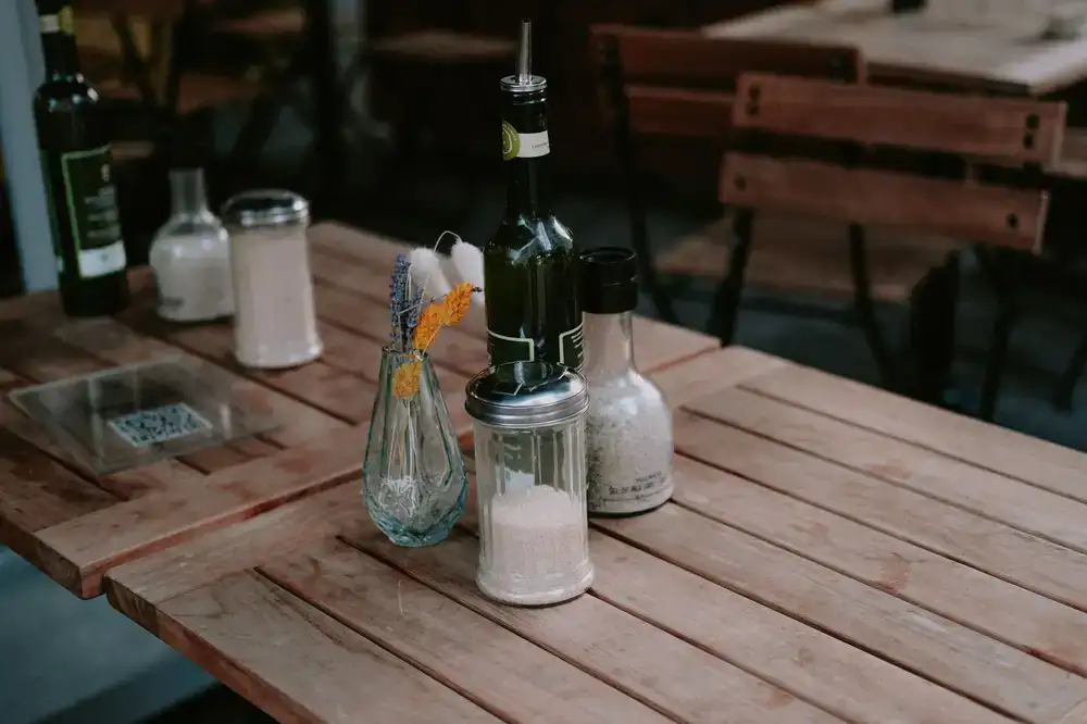 Bottles of fresh olive oil resting on a wooden table